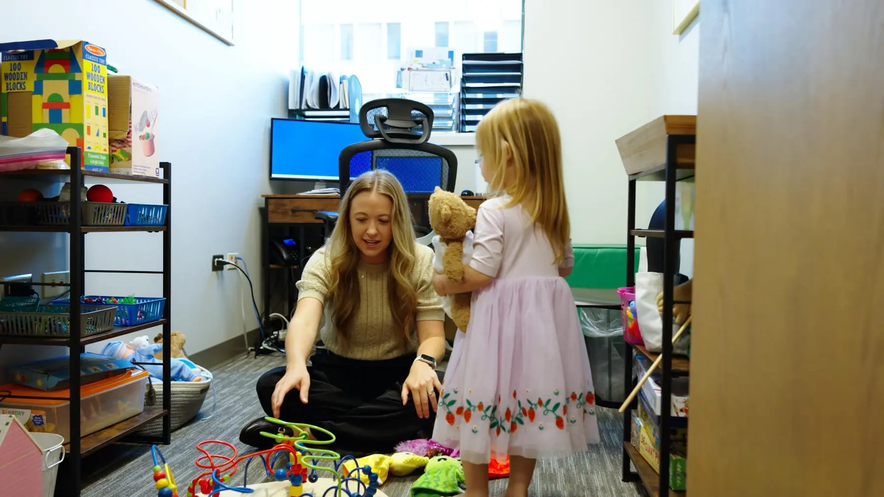A Sapphire Pediatrics care team member speaking with a child
