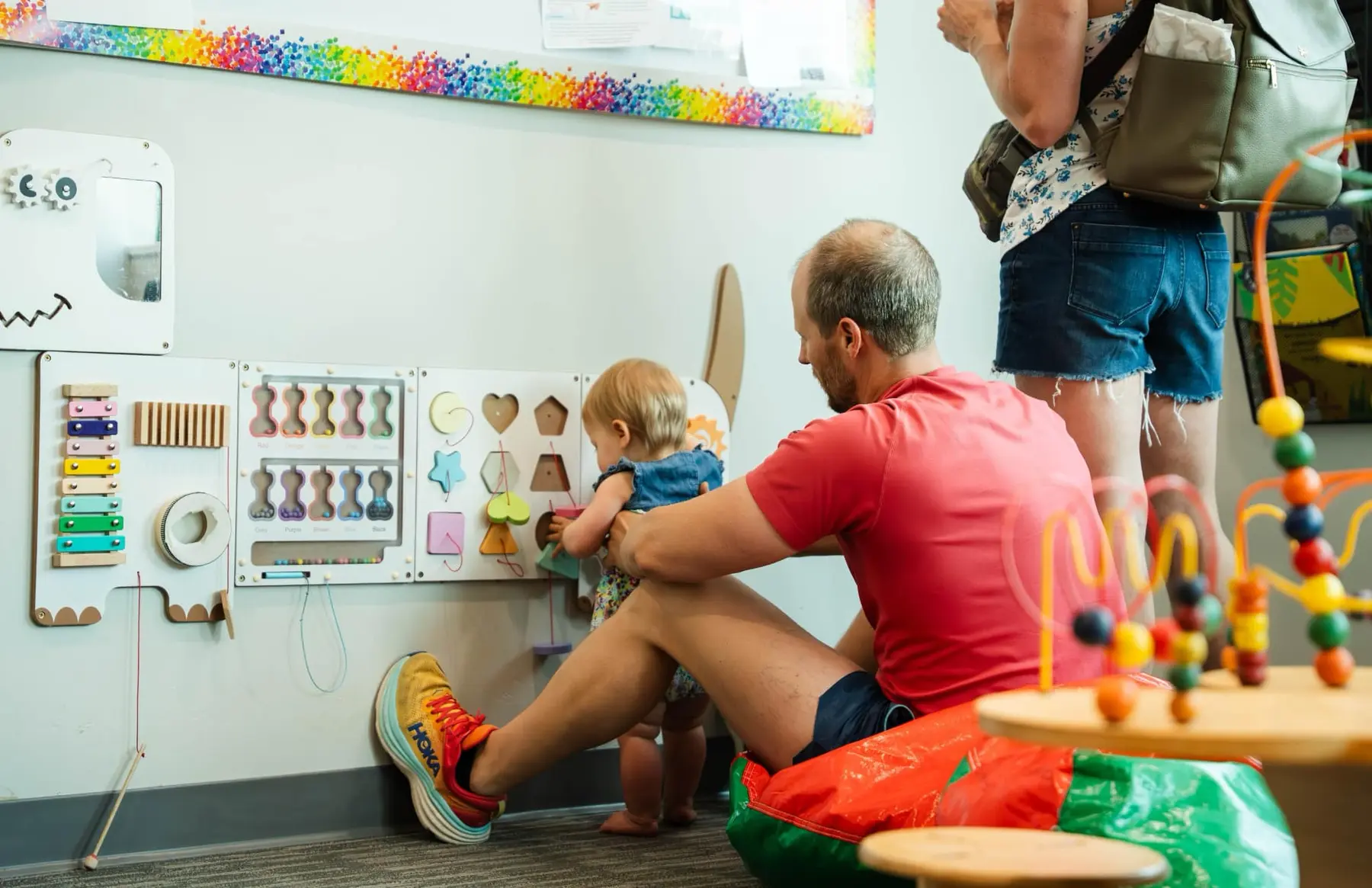 A parent and baby in the child-friendly office at Sapphire Pediatrics
