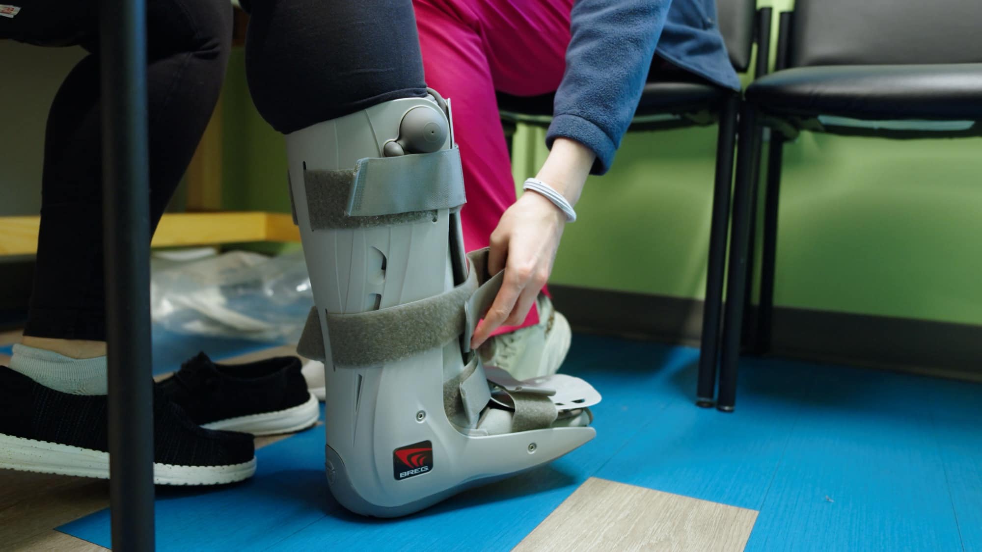 Care team member fitting a walking boot during an office visit