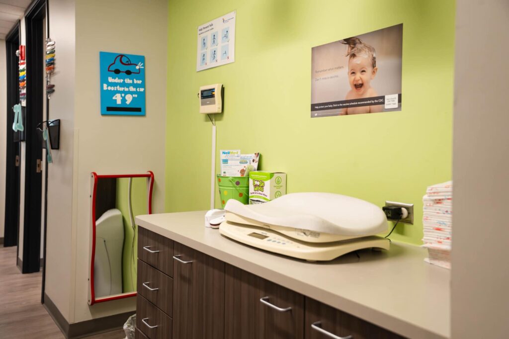 Empty infant scale and clinical counter in a Sapphire Pediatrics exam room