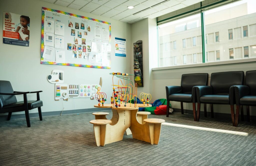 Waiting-room seating and a children’s activity table at Sapphire Pediatrics