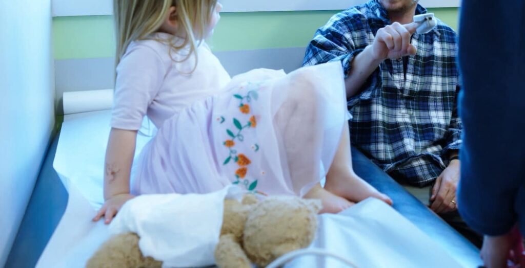 Child with an accompanying adult and care team member during an office visit
