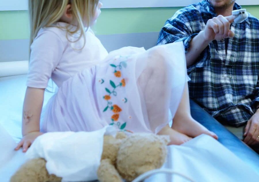 Child with an accompanying adult and care team member during an office visit
